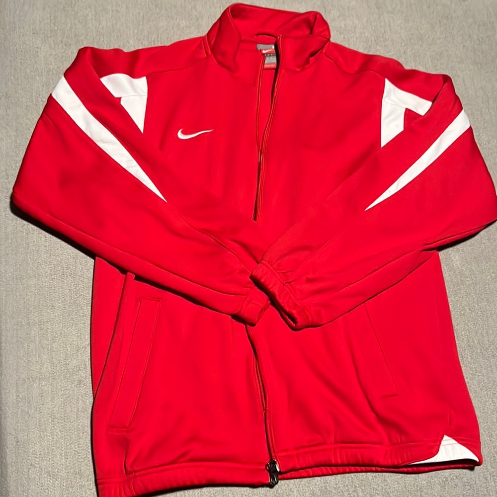 Red Nike zip-up with headphone or air pod compartment in jacket